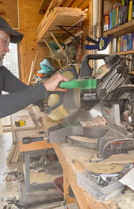 Wooden dowels being cut to size for the hanging interior structure